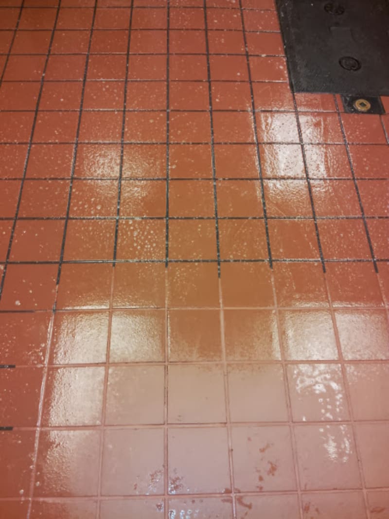 A red tiled floor in a gallery restaurant.