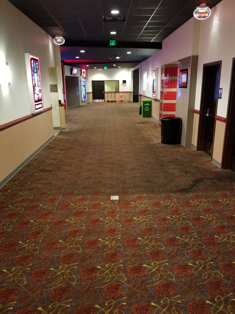 The gallery of a movie theater with red carpeting.