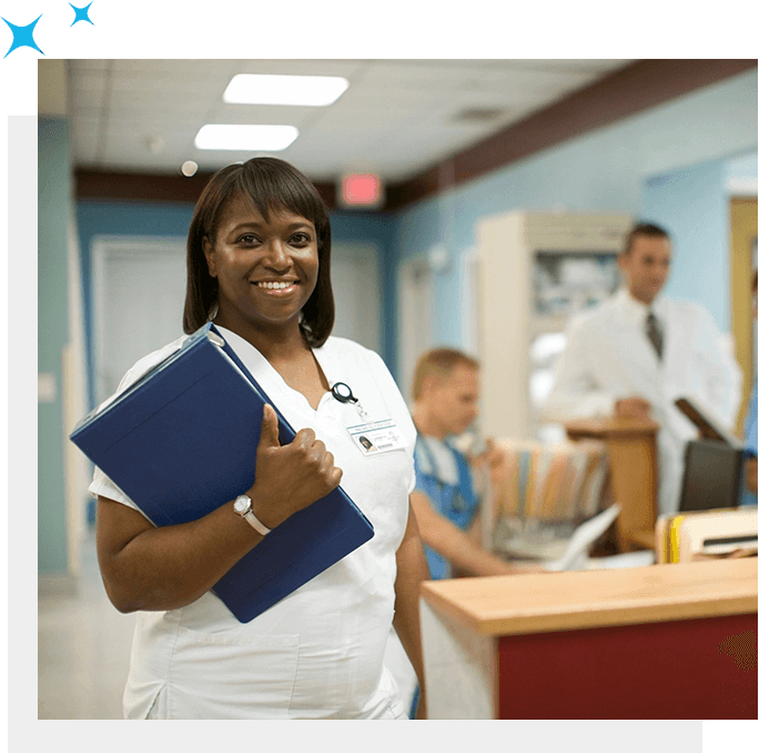 A staffing nurse smiling and holding a folder.