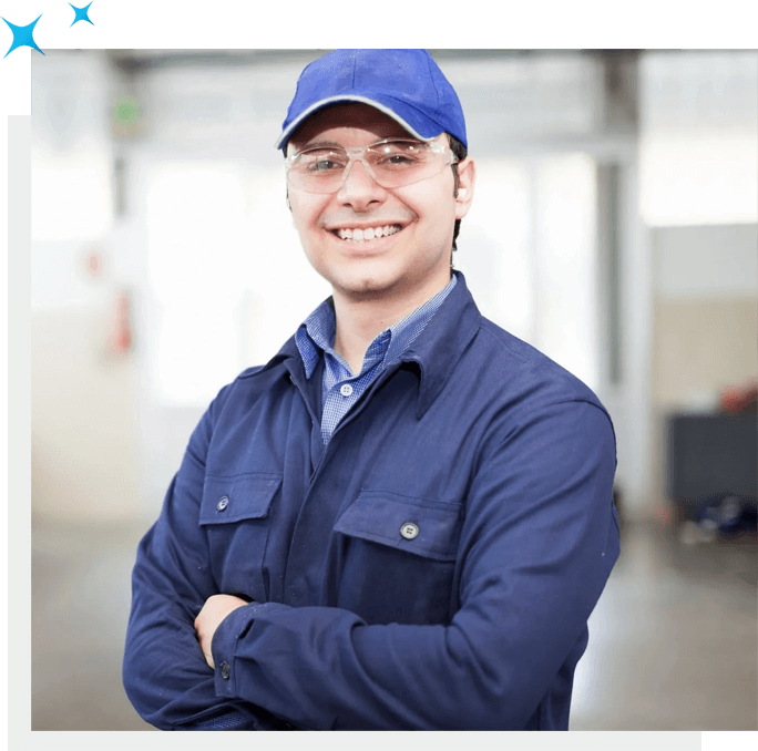 A smiling man wearing a blue hat and a blue shirt, holding Carpet Cleaning Solutions.